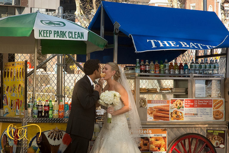 bride and groom eating hot dog in liberty park new york wedding photographer Ever Lopez NYC photography